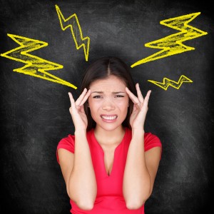 woman with hands on head and lightning bolts coming from head