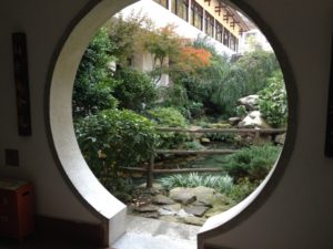 Garden through circle cut out in building