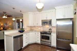 kitchen with white cupboards, stainless steel appliances